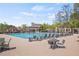 Relaxing community pool with lounge chairs and tables offers a great place to unwind and socialize at 390 Wilde Green Dr, Roswell, GA 30075