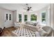 Bright sun room featuring large windows, comfortable seating, and wood-look flooring at 390 Wilde Green Dr, Roswell, GA 30075