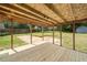 Covered wooden porch area with a view of the backyard at 58 6Th W Ave, Dallas, GA 30157