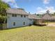 View of the home's backyard, exterior, and wooden deck at 58 6Th W Ave, Dallas, GA 30157