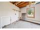 Unfinished basement space with exposed ceiling, concrete floor, window, and washer/dryer hookups at 58 6Th W Ave, Dallas, GA 30157