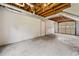 Unfinished basement space with exposed ceiling and concrete floor. Door leads to garage at 58 6Th W Ave, Dallas, GA 30157