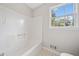 Bathroom featuring a shower/tub combo and a window for natural light at 58 6Th W Ave, Dallas, GA 30157