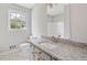 Bathroom with a granite countertop vanity, and a white tiled floor at 58 6Th W Ave, Dallas, GA 30157