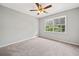 Spacious bedroom with neutral carpet, large window providing natural light, and a ceiling fan at 58 6Th W Ave, Dallas, GA 30157
