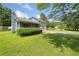 Side view of a two-story home with a well-manicured lawn and mature trees at 58 6Th W Ave, Dallas, GA 30157