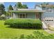 Charming one story section of home with trimmed hedges along the front porch at 58 6Th W Ave, Dallas, GA 30157