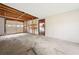 Unfinished garage with exposed ceiling and concrete floor. Has a garage door and pedestrian door at 58 6Th W Ave, Dallas, GA 30157