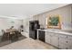 Clean kitchen featuring white cabinets, black appliances, and ample counter space for cooking at 58 6Th W Ave, Dallas, GA 30157