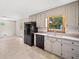 Bright kitchen featuring white cabinets and granite counters, with a black refrigerator at 58 6Th W Ave, Dallas, GA 30157
