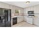 Traditional kitchen features white cabinets, granite countertops, and black appliances at 58 6Th W Ave, Dallas, GA 30157