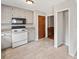 A bright kitchen with white cabinets, tile flooring, and stainless steel appliances at 58 6Th W Ave, Dallas, GA 30157