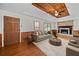 Inviting living room with a stone fireplace, wood paneling, and wood-beamed ceilings at 58 6Th W Ave, Dallas, GA 30157