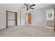Main bedroom with carpet flooring, closet, en suite, and ceiling fan at 58 6Th W Ave, Dallas, GA 30157