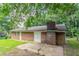 Backyard with brick exterior and chimney surrounded by lush green trees providing shade and privacy to the home at 4337 Brookside Dr, Forest Park, GA 30297