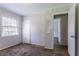 This bedroom features a closet, window with blinds, and neutral wall and door paint at 4337 Brookside Dr, Forest Park, GA 30297