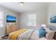 Modern primary bedroom boasts neutral colors, wood floors, and natural light at 4337 Brookside Dr, Forest Park, GA 30297