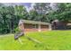 Charming brick home with a well-kept lawn, featuring stairs leading to the entrance and surrounded by verdant trees at 4337 Brookside Dr, Forest Park, GA 30297