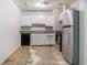This kitchen features white cabinets, stainless steel refrigerator, and black appliances at 4337 Brookside Dr, Forest Park, GA 30297
