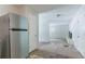 This kitchen features a stainless steel refrigerator and leads to a living room and other parts of the house at 4337 Brookside Dr, Forest Park, GA 30297