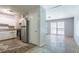 This kitchen features white cabinets, stainless steel refrigerator, and black appliances and flows into the living room at 4337 Brookside Dr, Forest Park, GA 30297