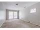 This living room features neutral walls, two windows with blinds, and a ceiling light at 4337 Brookside Dr, Forest Park, GA 30297