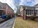 Brick home with screened porch and a view of the side yard, with mature trees and lawn at 472 Parkway Ne Dr, Atlanta, GA 30308