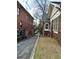 Brick home with screened porch with a view of the driveway, mature trees, and a grassy lawn at 472 Parkway Ne Dr, Atlanta, GA 30308