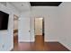 Bright bedroom with hardwood floors and white walls leading to closets and other rooms at 855 Peachtree Ne St # 1108, Atlanta, GA 30308