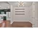 Dining space with hardwood floors, open shelves, and view into the modern kitchen at 855 Peachtree Ne St # 1108, Atlanta, GA 30308