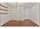 Entryway with hardwood floors, modern light fixture, and white doors at 855 Peachtree Ne St # 1108, Atlanta, GA 30308