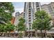 Contemporary high-rise building with tree lined sidewalks and ground floor shops at 855 Peachtree Ne St # 1108, Atlanta, GA 30308