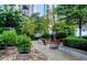 Serene rooftop garden features lush greenery, manicured shrubs, and cozy seating areas at 855 Peachtree Ne St # 1108, Atlanta, GA 30308