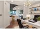 Modern home office leads into the kitchen with a large island, stainless steel appliances, and green cabinets at 855 Peachtree Ne St # 1108, Atlanta, GA 30308