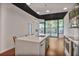 Modern kitchen features a marble island, stainless steel appliances, and sleek green cabinetry at 855 Peachtree Ne St # 1108, Atlanta, GA 30308