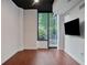 Well-lit living room with hardwood floors, concrete accent, a large window, and a mounted flatscreen TV at 855 Peachtree Ne St # 1108, Atlanta, GA 30308