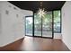 Open floorplan showcasing hardwood floors, a modern chandelier, and large windows overlooking greenery at 855 Peachtree Ne St # 1108, Atlanta, GA 30308