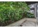 Relaxing patio with lush greenery, a concrete retaining wall, and a serene outdoor ambiance at 855 Peachtree Ne St # 1108, Atlanta, GA 30308