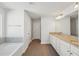 Bright bathroom featuring double vanity with granite counters and tile flooring at 11857 Rizvan Pl, Covington, GA 30014