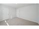 Spacious bedroom with soft carpet and crisp white doors, creating a blank canvas for personalized decor at 11857 Rizvan Pl, Covington, GA 30014
