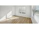 Bright bedroom with hardwood floors, natural light from the window, and a closet door at 11857 Rizvan Pl, Covington, GA 30014