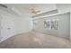 Spacious bedroom boasts tray ceiling, ceiling fan, and abundant natural light, enhancing its tranquil ambiance at 11857 Rizvan Pl, Covington, GA 30014