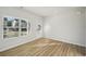 Sunlit bedroom with durable hardwood floors, an exterior door, and bright windows at 11857 Rizvan Pl, Covington, GA 30014