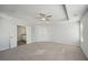 Light-filled bedroom with tray ceiling, ceiling fan, and ensuite bathroom access offers luxury and relaxation at 11857 Rizvan Pl, Covington, GA 30014