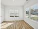 Bright bedroom with hardwood floors, large windows, and a closet door at 11857 Rizvan Pl, Covington, GA 30014