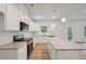 Modern kitchen featuring white cabinets, granite countertops, and stainless steel appliances at 11857 Rizvan Pl, Covington, GA 30014