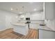 Spacious kitchen featuring white cabinets, granite countertops, and a center island at 11857 Rizvan Pl, Covington, GA 30014