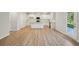 Bright, open kitchen with white cabinets and stainless steel appliances; blends with dining and living area at 11857 Rizvan Pl, Covington, GA 30014