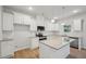 Modern kitchen features white cabinets, granite countertops, and stainless steel appliances at 11857 Rizvan Pl, Covington, GA 30014