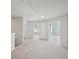 Upstairs landing with neutral carpet flooring leading to bedroom and bathroom entrances at 11857 Rizvan Pl, Covington, GA 30014